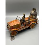A German tinplate clockwork sparking fire engine. Possibly by Arnold with three tin firemen. In a