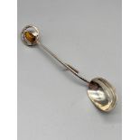 A Vintage Edinburgh silver honey spoon, designed with a bee top with a tiger eye stone insert.