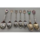 A Lot of seven Birmingham Silver souvenir tea spoons. Some designed with enamel tops.