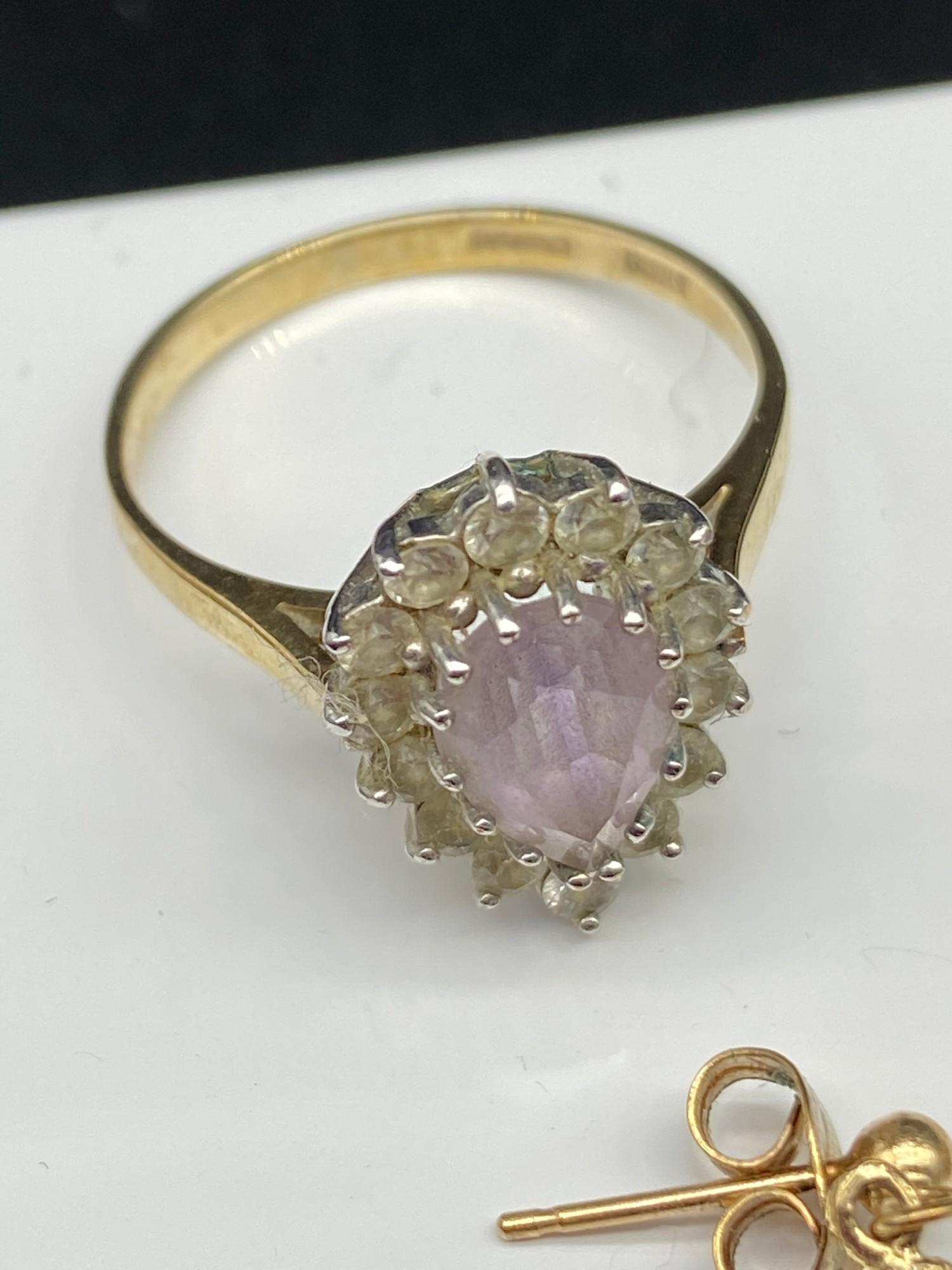 A 9ct gold ladies ring set with a pale purple tear drop stone surrounded by clear stones, Together - Image 3 of 4