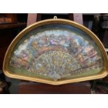 An 19th century hand painted fan and mother of pearl sections within a fitted gilt frame.