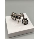 A Silver 925 articulated motorcycle. [4.5cm in length]
