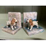 A Pair of art deco cold painted spelter spaneil figure bookends. Spaniels stood upon alabaster