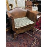 An 18th/19th century Jacobean style Childs tub chair. Bound in brown leather and finished with