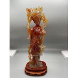 A 19th Century Chinese hand carved red agate Geisha figurine. Sat upon a hardwood stand. [24.5cm