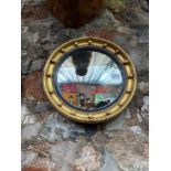 A Regency style Convex mirror. Designed with moulded trims and spheres. [