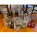 A Lot of various sized decanters which includes a crystal ships decanter, Cranberry decanter jug and