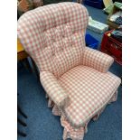 An antique button back bedroom arm chair