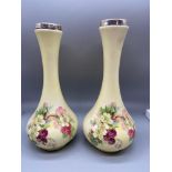 A Pair of flower design bud vases fitted with silver rim mounts.