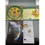 The Royal Mint 'UK Brilliant Uncirculated coin collection' and Millennium 2000 five pound coin.