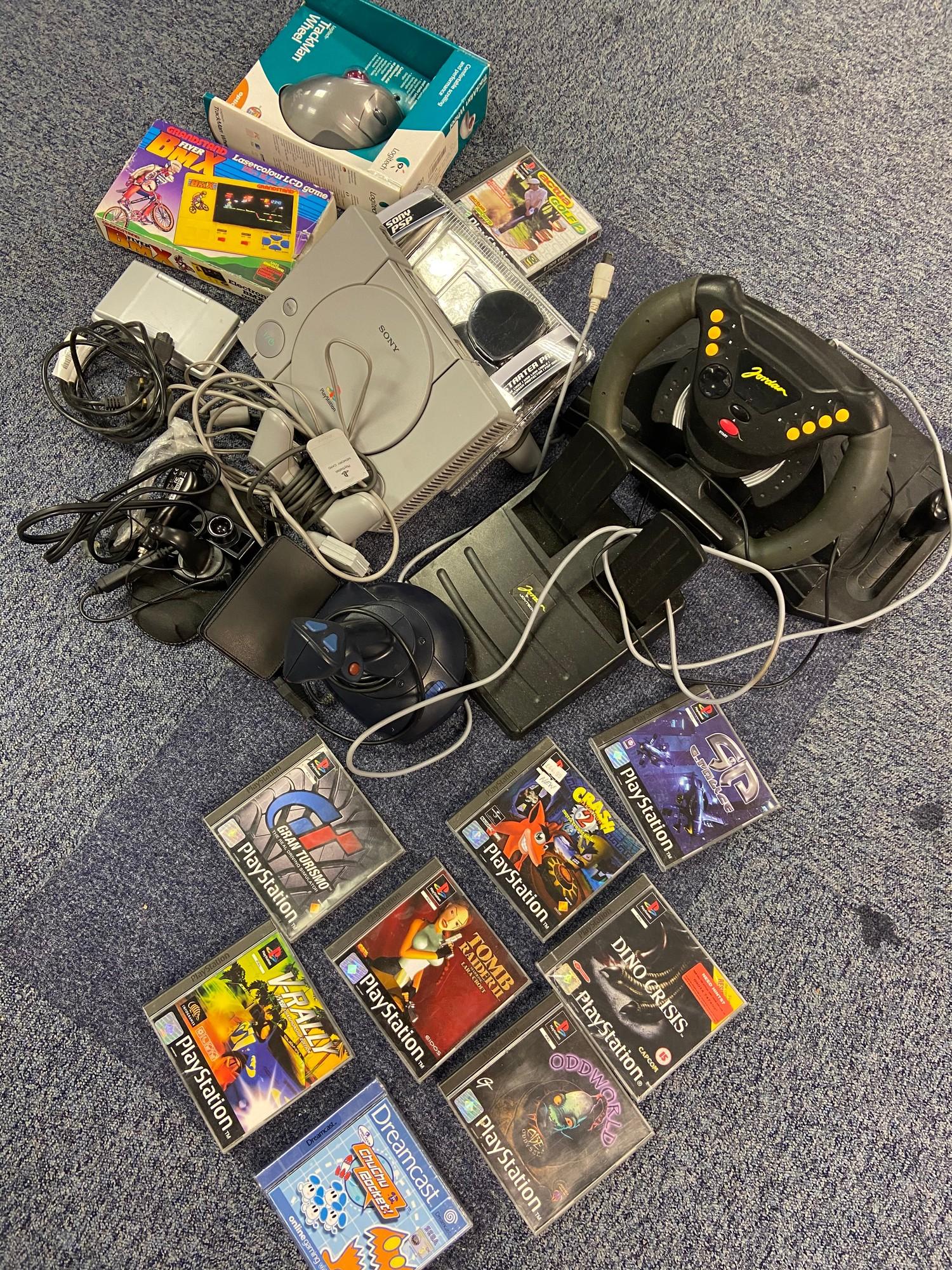 A Selection of various console items which includes a Playstation one with controller and games.