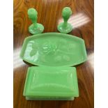 An Art Deco Uranium dressing table set. Consists of tray with rose design, Trinket box and a pair of