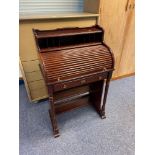 A Good quality roll top dark wood writing bureau. Designed with pedestal supports.
