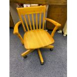 A Solid pine work station chair with arm rests.