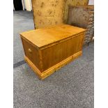 A Hard wood linen chest designed with brass side handles.