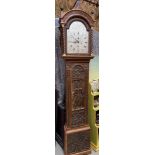 A Unique Antique long cased grandfather clock depicting a hand carved casing which shows Richard