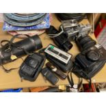 A Selection of vintage Cameras and lenses to include Minolta SRT101, Cosina CX-1 Camera and