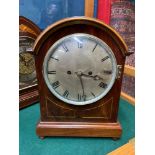 An Antique Mahogany cased mantle clock. Fusie clock movement. Lion head and hoop side hinges.