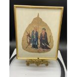 An Antique hand painted Pipal leaf framed. Depicting two elderly figures, one with an deer to his