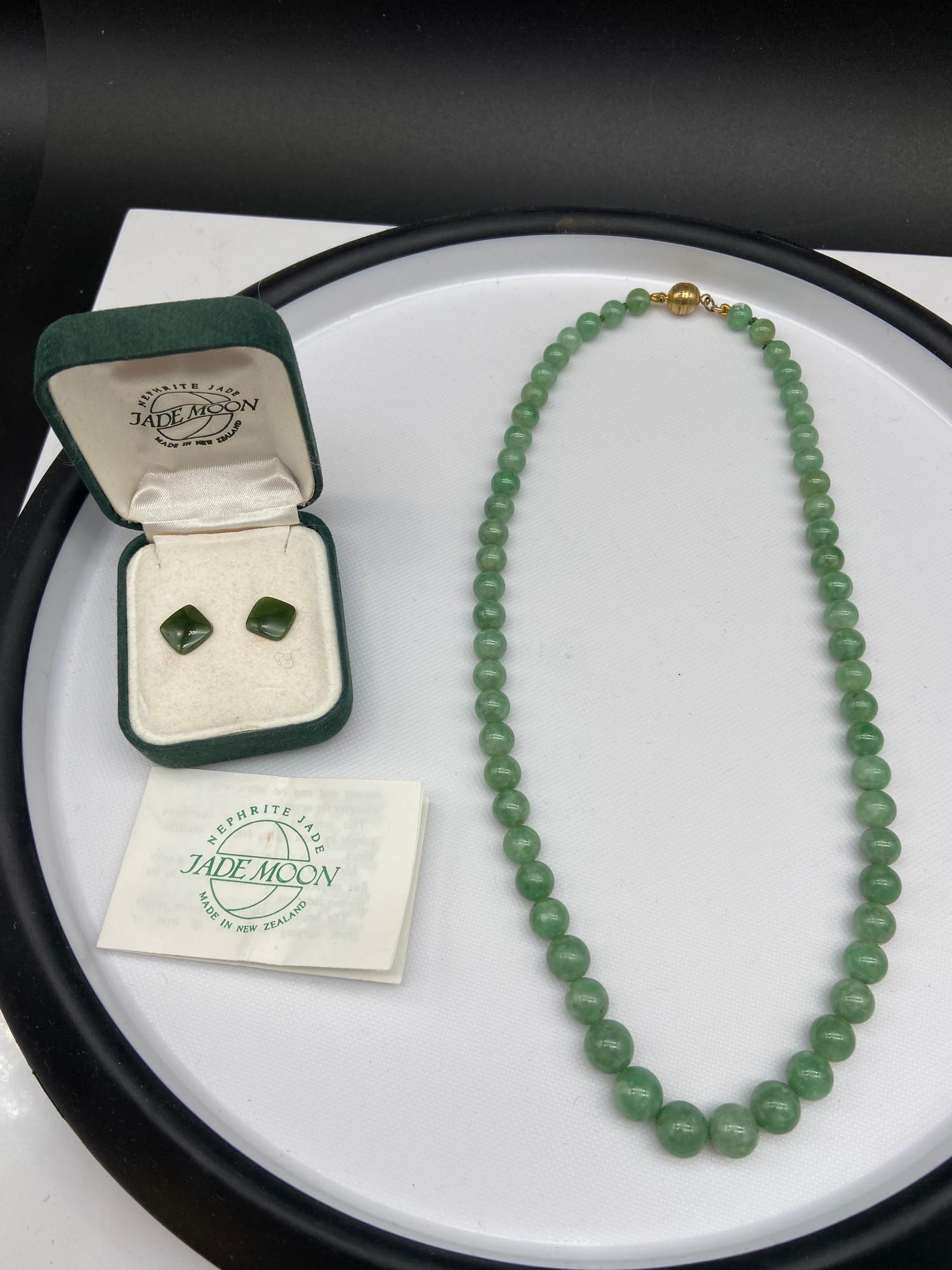 A Vintage jade graduating bead necklace together with a pair of green jade earrings.