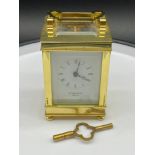 A Vintage Taylor & Bligh England brass carriage clock, designed with bevel glass panels and comes