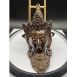 An Antique Bronze Chinese buddha head wall hanger. Showing signs of finger prints to the back on