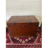 An Antique oak travel trunk fitted with metal bounds , side handles and finished with an interior