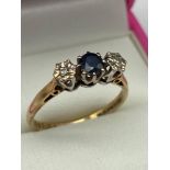 A 9ct gold Diamond and Sapphire ring. [Ring size P] [2.30GRAMS]