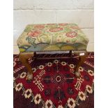 A 19th century dressing table stool, designed with a floral tapestry top and carved claw and ball