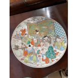 A Large 19th century Japanese hand painted wall charger. Designed with various characters, birds and