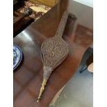 An Arts and crafts hand carved oak fire bellows, designed with long handles,