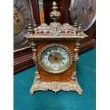 A Victorian brass bound and burr walnut mantle clock. Designed with a picture dial face. [26cm in
