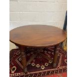 A 19th century Mahogany round dining table designed with a cross section bracer support. [110cm