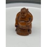 A Japanese hand carved netsuke of a sumo wrestler, signed. [5cm in height]