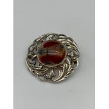A Scottish Silver thistle and agate stone brooch. [Stamped 'Scotland' & 'Silver'] [4cm in diameter]