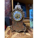 An Antique French Tortoise shell and brass inlay Boullework mantle clock. Designed with gilt