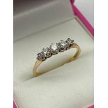 A Ladies gold [Rubbed mark] five stone ring. [2.10grams] [Ring size P]