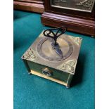 An Antique Konigsberg single hand table clock. Designed in a brass casing and raised relief cherub