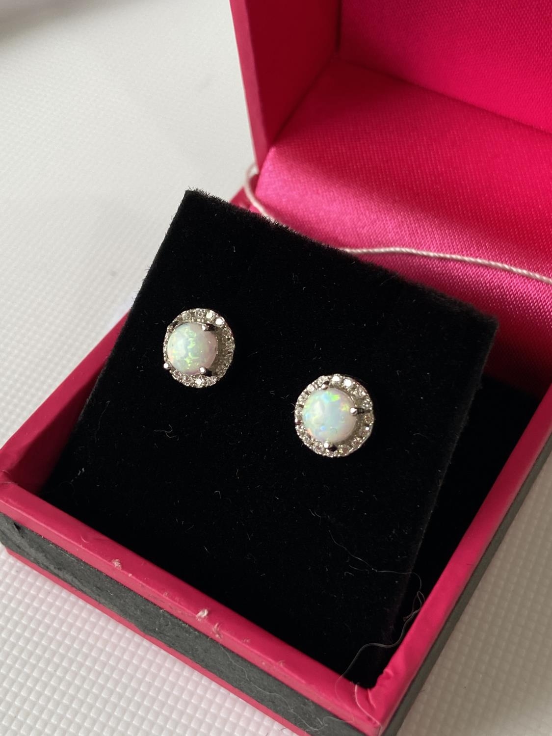 A Pair of silver CZ and Opal stud earrings.