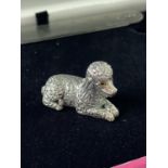 A Silver figure of a poodle dog. [3.2cm in length]