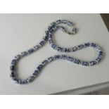 A CHINESE BLUE AND WHITE CERAMIC BEAD NECKLACE