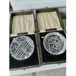 Two boxed cut crystal butter dishes with silver butter knives.