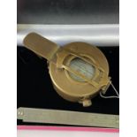 A Brass cased military style compass.