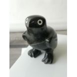 A Nice example of a hand carved Inuit bird figurine made from a hard stone, showing red & white