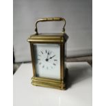 An antique heavy brass and glass carriage clock. In a working condition. [15x10x9cm]