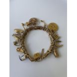 A nice example of a vintage 9ct gold heavy charm bracelet to include; 14ct gold USA golf association