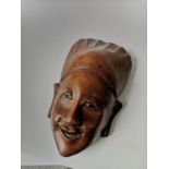 A Hand carved Chinese face mask detailed with glass eyes and ivory teeth. [12x7x3.4cm]