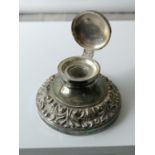 An antique ornate white metal/ plated ink well pot with glass insert. [5.5x9.5x9.5cm]