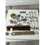 A Selection of various silver items to include souvenir spoons, ring, brooches and napkin rings etc.