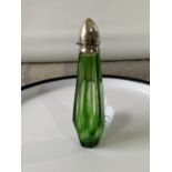 A Faceted green glass perfume bottle with a silver top [tested] [11.5cm in length]